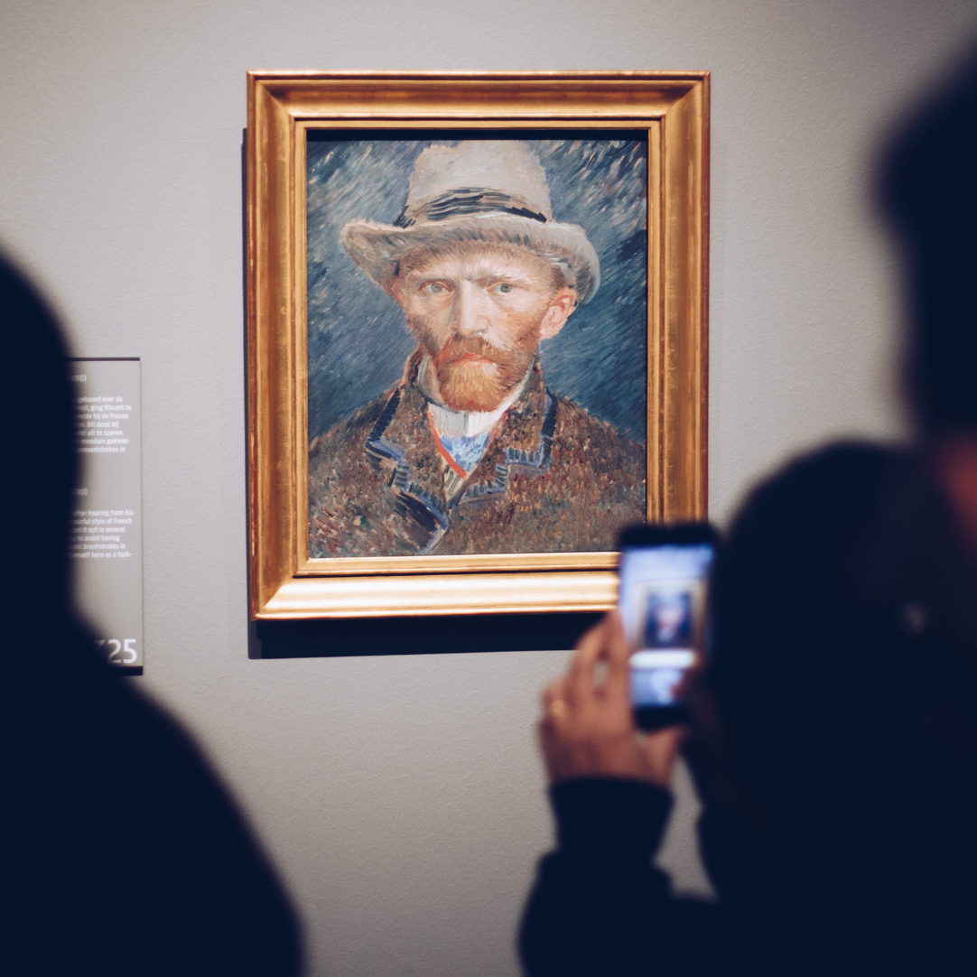 Bezoekers maken een foto van een schilderij in een museum